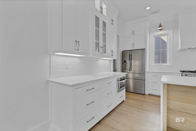 309-C S School St, Fairhope, AL 36532 - kitchen with decorative backsplash, white cabinetry, light countertops, and high end fridge