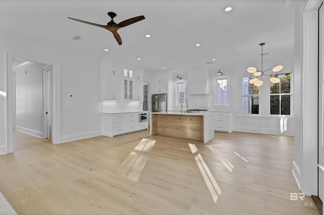 309-C S School St, Fairhope, AL 36532 - interior space featuring high quality fridge, baseboards, ceiling fan with notable chandelier, and custom range hood
