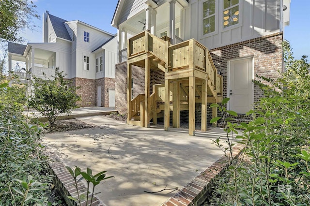 309-C S School St, Fairhope, AL 36532 - rear view of house with stairs, board and batten siding, and brick siding