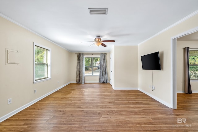 empty room with crown molding, ceiling fan, and light hardwood / wood-style floors