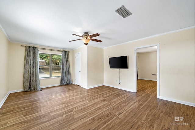 spare room with crown molding, ceiling fan, and wood-type flooring