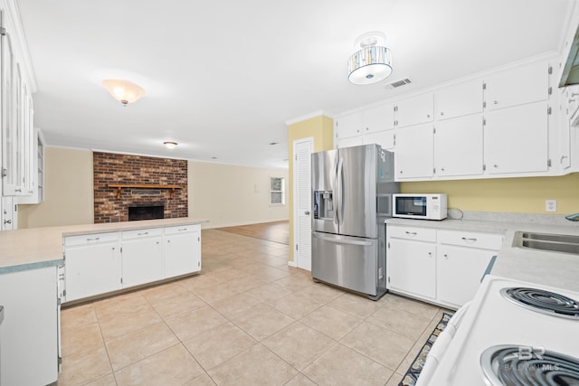 kitchen with white cabinetry, sink, light tile patterned floors, crown molding, and white appliances