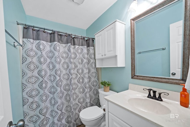 bathroom featuring vanity, curtained shower, and toilet