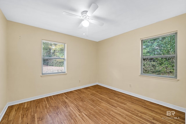 unfurnished room featuring hardwood / wood-style flooring and ceiling fan