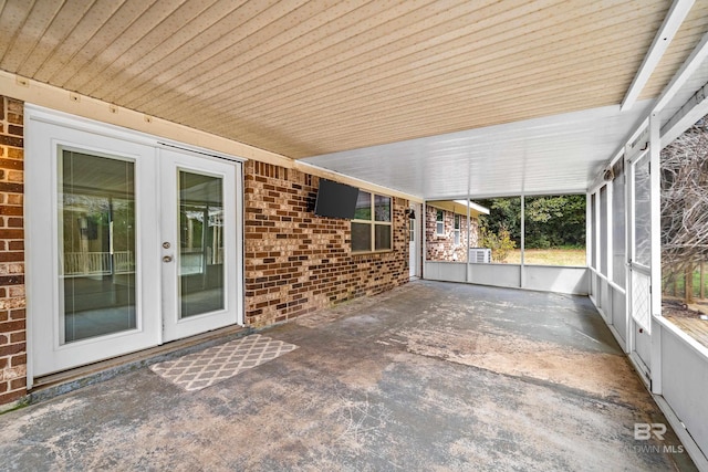 unfurnished sunroom with wooden ceiling and french doors