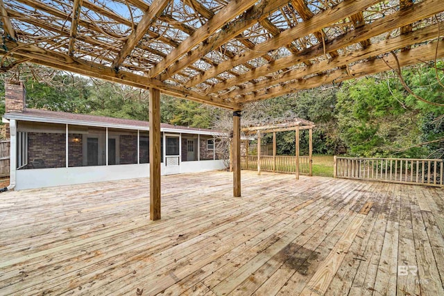 deck with a pergola and a sunroom