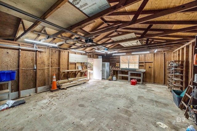 garage with stainless steel refrigerator