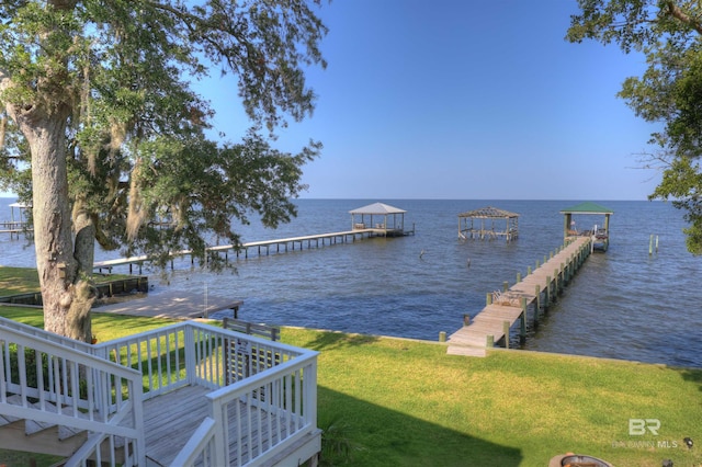 dock area with a water view and a lawn