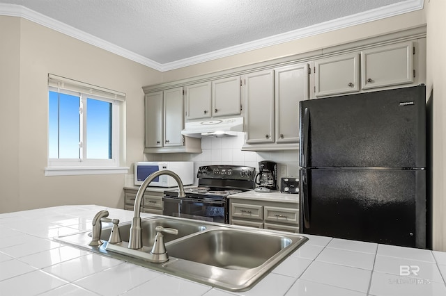 kitchen featuring crown molding, backsplash, black appliances, a textured ceiling, and tile countertops