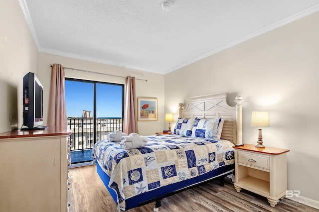 bedroom featuring crown molding, access to exterior, hardwood / wood-style flooring, and a textured ceiling