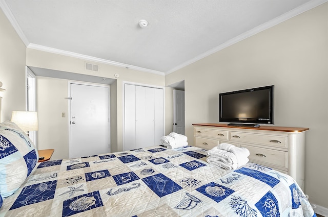 bedroom with ornamental molding and a closet