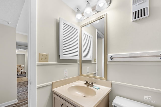 bathroom featuring vanity and toilet