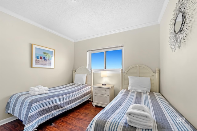 bedroom featuring dark wood-type flooring, ornamental molding, and a textured ceiling