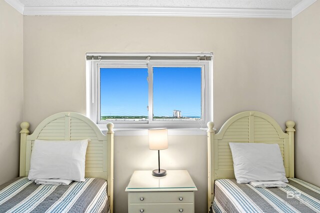 bedroom with ornamental molding and a textured ceiling