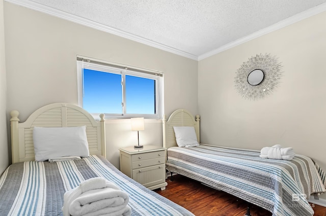 bedroom with dark hardwood / wood-style flooring, crown molding, and a textured ceiling