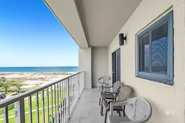 balcony featuring a water view and a view of the beach