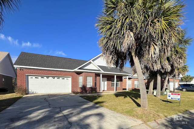 view of front of house with a front yard and a garage