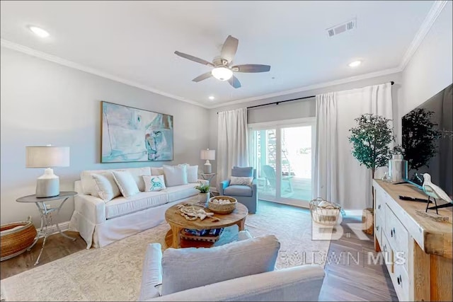 living room with ceiling fan, hardwood / wood-style floors, and crown molding