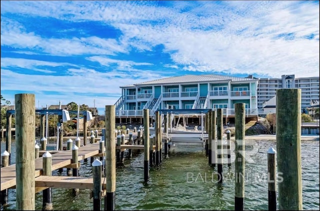 dock area with a water view and boat lift