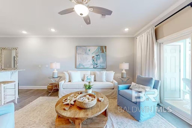 living room with hardwood / wood-style floors, ornamental molding, and ceiling fan