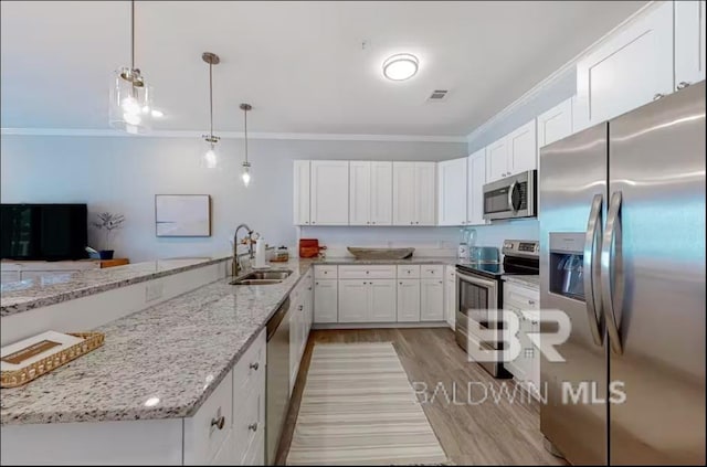 kitchen featuring visible vents, white cabinets, appliances with stainless steel finishes, crown molding, and a sink