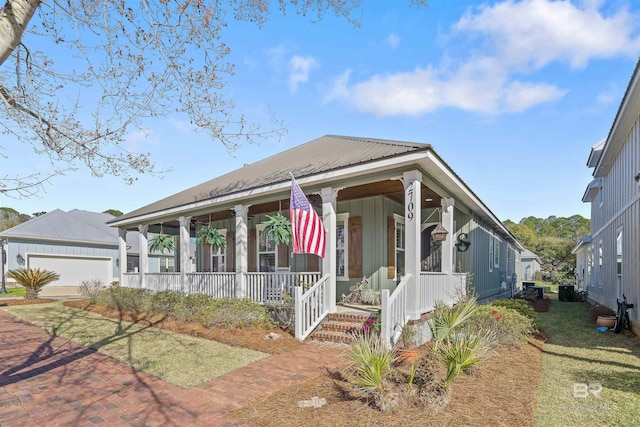 view of front of house with a garage, decorative driveway, a porch, and metal roof