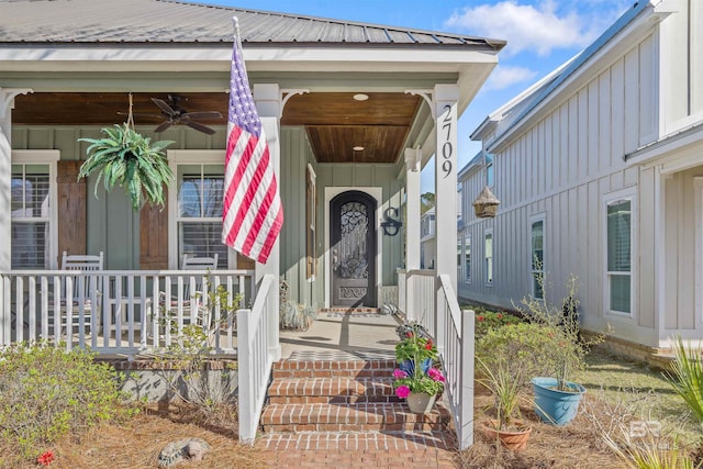 property entrance with metal roof, board and batten siding, covered porch, and a ceiling fan