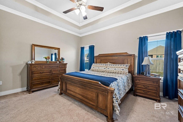 bedroom with baseboards, ceiling fan, ornamental molding, a raised ceiling, and light colored carpet