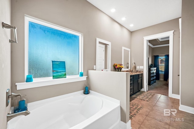 bathroom featuring vanity, a garden tub, plenty of natural light, and tile patterned floors