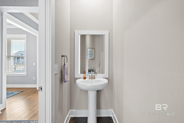 bathroom featuring wood finished floors and baseboards