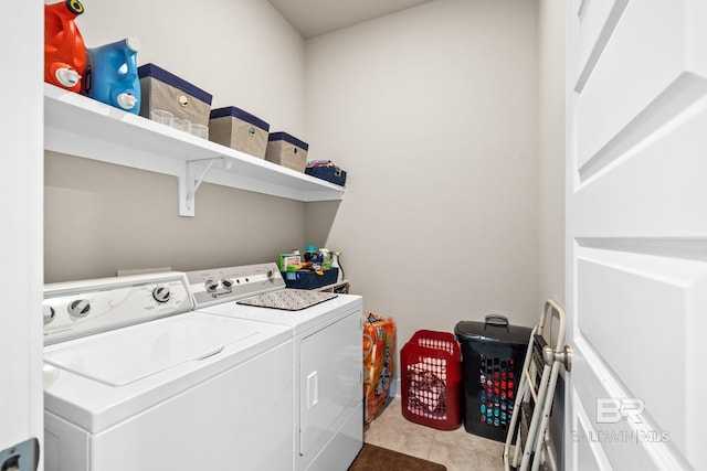 laundry area with washing machine and clothes dryer, laundry area, and tile patterned flooring