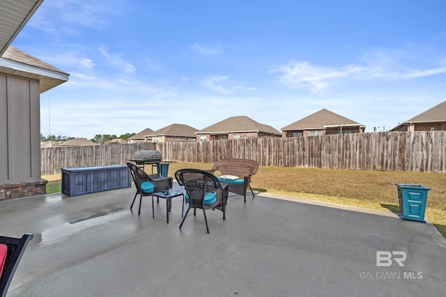 view of patio with grilling area and a fenced backyard