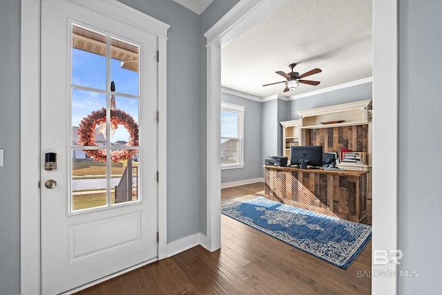 office area with a textured ceiling, wood finished floors, crown molding, baseboards, and ceiling fan