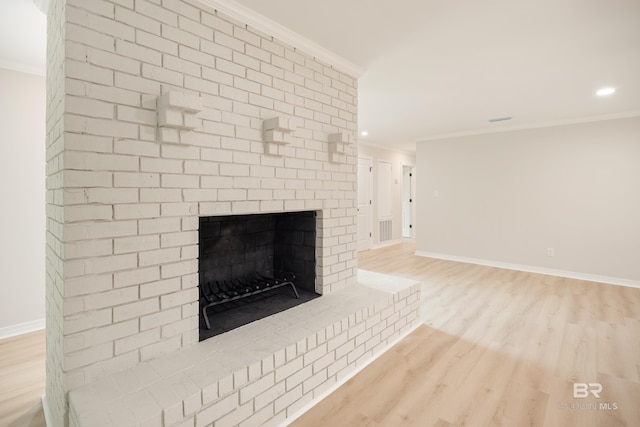 interior details featuring hardwood / wood-style floors, ornamental molding, and a fireplace