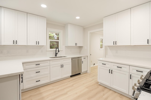 kitchen with white cabinets, light wood-type flooring, sink, and appliances with stainless steel finishes