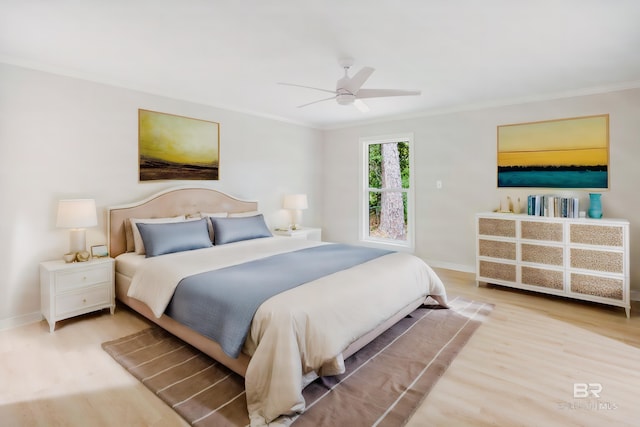 bedroom with ceiling fan, ornamental molding, and light hardwood / wood-style flooring