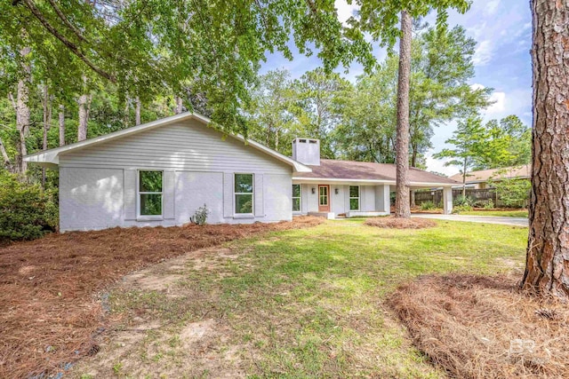 ranch-style house with a carport and a front lawn