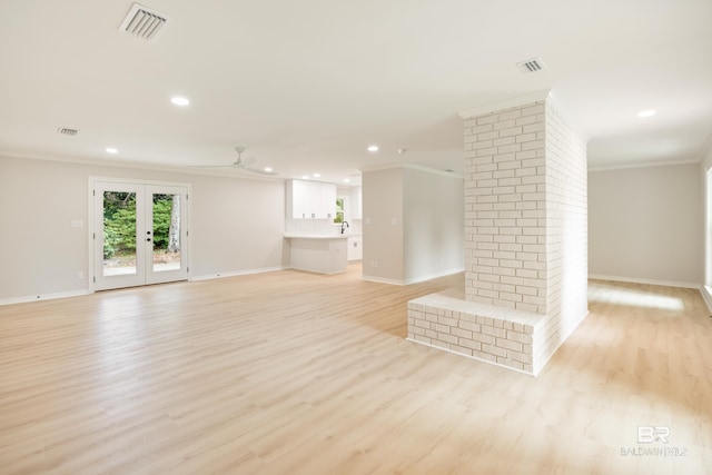 unfurnished living room featuring french doors, sink, ceiling fan, ornamental molding, and light hardwood / wood-style floors