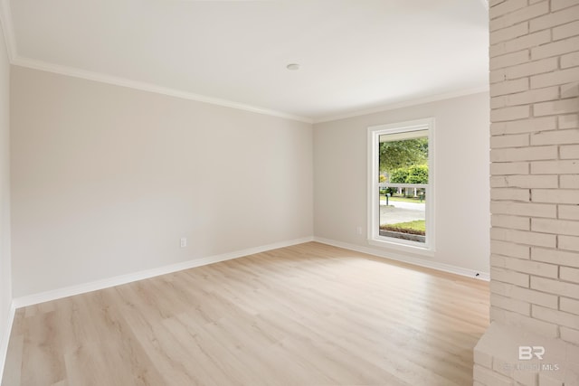 spare room with light wood-type flooring and ornamental molding