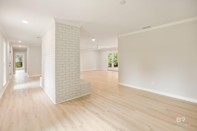 spare room with light wood-type flooring, ceiling fan, and crown molding