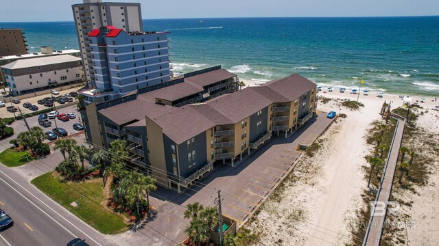 drone / aerial view with a water view and a view of the beach