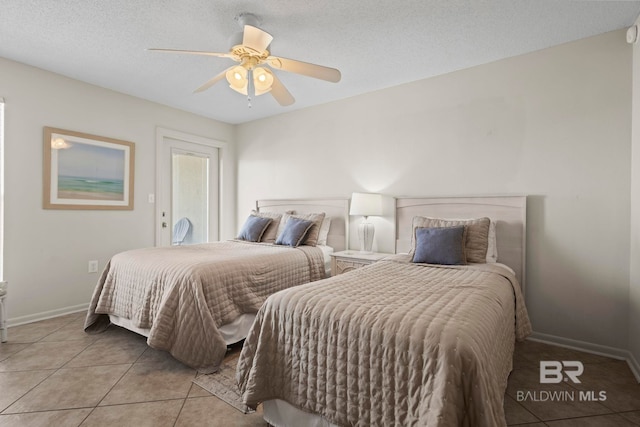 1069 W Beach Blvd Unit 5C, Gulf Shores, AL 36542 - bedroom featuring light tile patterned floors, a ceiling fan, and a textured ceiling