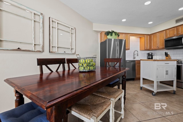 1069 W Beach Blvd Unit 5C, Gulf Shores, AL 36542 - kitchen with appliances with stainless steel finishes, decorative backsplash, light countertops, recessed lighting, and light tile patterned flooring