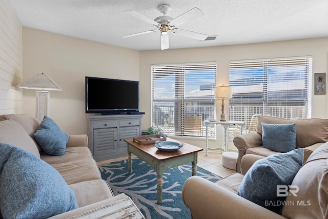 1069 W Beach Blvd Unit 5C, Gulf Shores, AL 36542 - living room featuring a ceiling fan, a textured ceiling, and light tile patterned floors