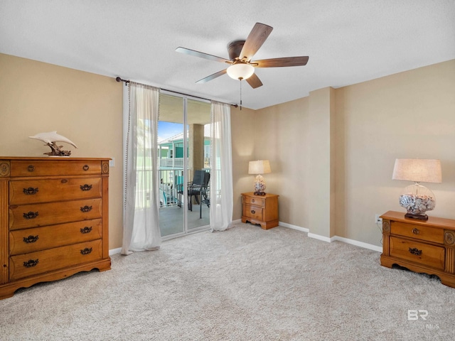 1516 Sandpiper Ln Unit 209, Gulf Shores, AL 36542 - bedroom featuring access to outside, ceiling fan, light colored carpet, and a textured ceiling