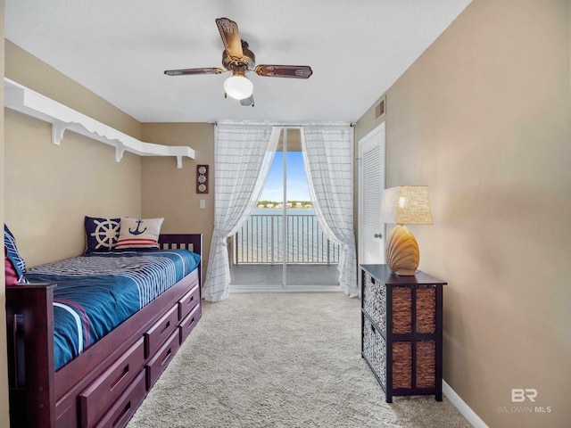 1516 Sandpiper Ln Unit 209, Gulf Shores, AL 36542 - bedroom with ceiling fan, light carpet, and access to outside