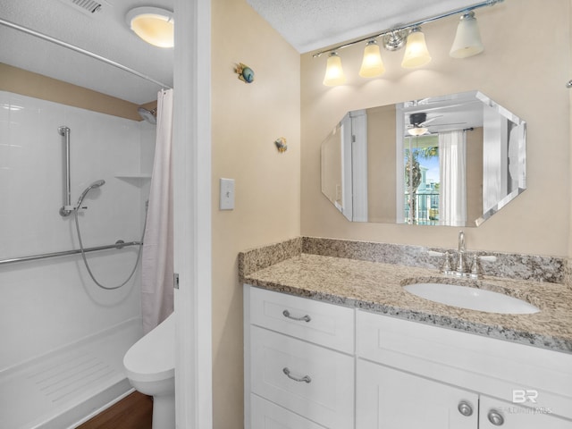 1516 Sandpiper Ln Unit 209, Gulf Shores, AL 36542 - bathroom with curtained shower, vanity, a textured ceiling, and ceiling fan