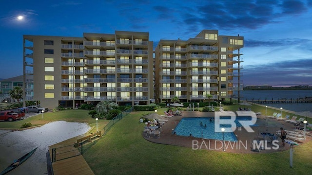 1516 Sandpiper Ln Unit 209, Gulf Shores, AL 36542 - pool at dusk featuring a water view