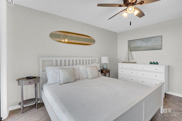 bedroom with light tile patterned floors, baseboards, and ceiling fan