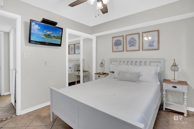 bedroom with light tile patterned floors, baseboards, and ceiling fan